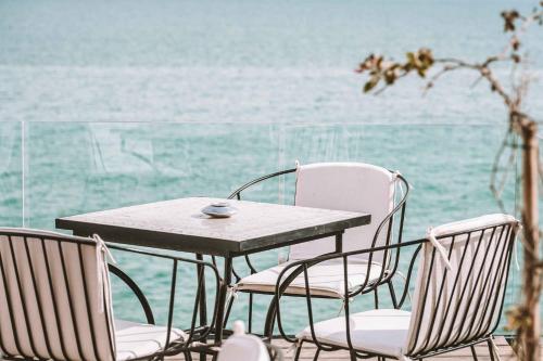 a table with two chairs and a table with a cup on it at Hôtel Oasis Dakhla in Dakhla