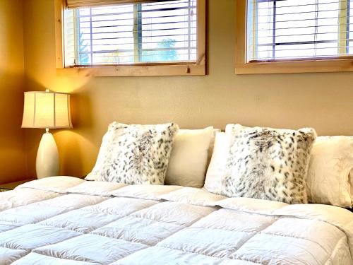 a bedroom with a bed with pillows and a window at The Raspberry Garden in Rexburg