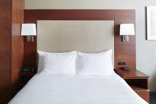 a bedroom with a large bed with white pillows at River Hotel in Chicago