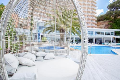 a swimming pool with a canopy and chairs at Bahia Principe Sunlight Coral Playa in Magaluf