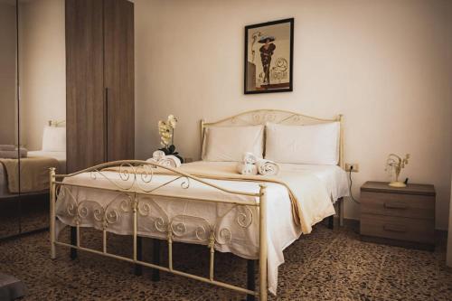 a bedroom with a bed with two stuffed animals on it at I 7 Peccati in Marina di Mancaversa