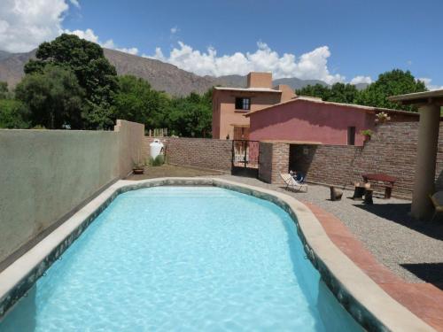 a swimming pool in the yard of a house at Cabañas Luna y Sol in Cafayate