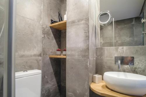 a bathroom with a white sink and a toilet at Casa 36 Exquisite Flat in Lisbon