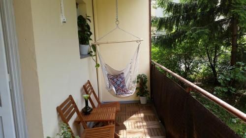 a porch with two chairs and a hammock on the wall at Green Oasis in Berlin