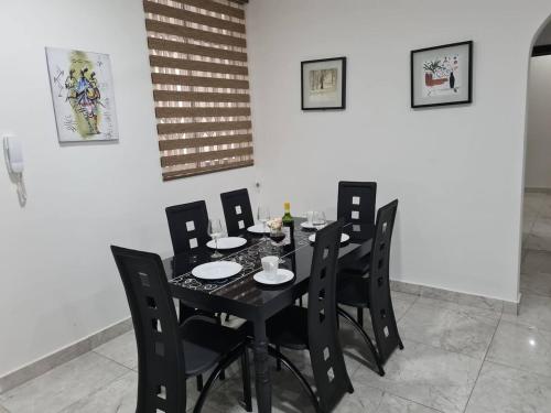 a black dining room table with black chairs at Gorgeous Quiet & Comfy-Close to Highway-Parking in Apenkwa