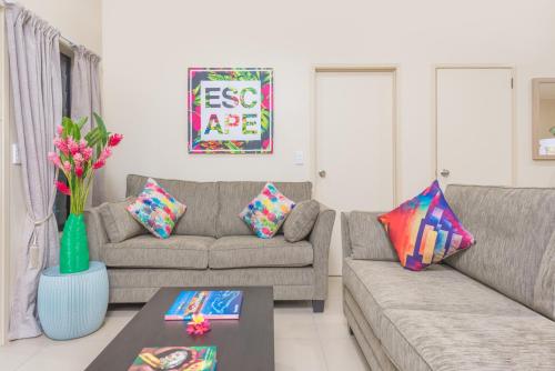 a living room with a couch and a table at Cook Islands Holiday Villas-Tuoro Holiday in Rarotonga