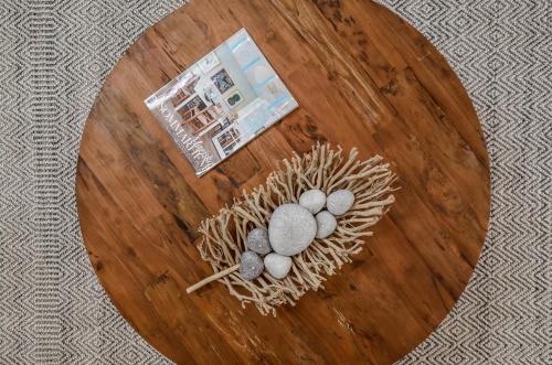 a wooden table with three eggs in a nest on it at Sea & Olives Suites Hotel and Villas in Plaka