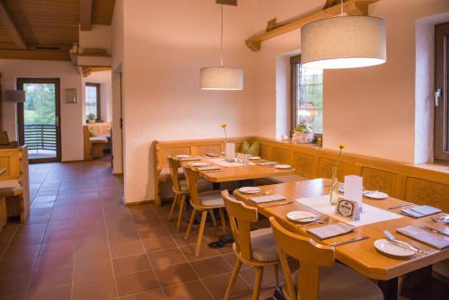 a dining room with wooden tables and chairs at Hotel Restaurant Brigitte in Warmensteinach