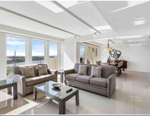 a living room with two couches and a table at Bahia Mar Solare Tower 6th floor Bayview Condo 2bd 2ba with Pools and Hot tubs in South Padre Island