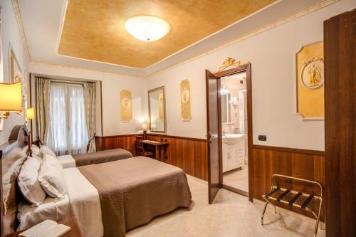 a hotel room with a bed and a bathroom at Nakissa Inn in Rome
