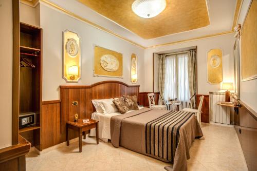 a hotel room with a bed and a table at Nakissa Inn in Rome
