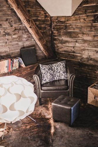 a living room with a chair and a table at Penzion Adamův Dvůr in Masákova Lhota