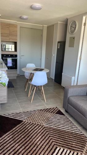 a living room with a table and a couch at Apart Center Temuco in Temuco