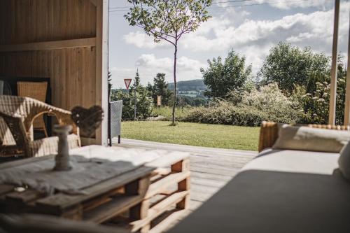 a patio with a table and a view of a yard at Penzion Adamův Dvůr in Masákova Lhota
