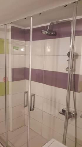 a bathroom with a glass shower with a toilet at cELLATE cozy home in Chalkida