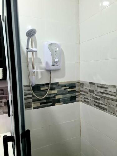a shower with a blow dryer in a bathroom at Spacious Quiet & Cozy- Close to Highway-Parking in Apenkwa