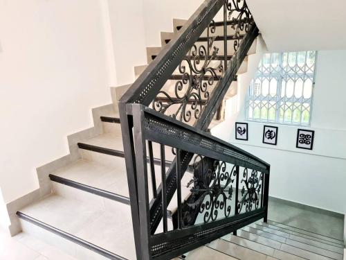 a staircase with black railings and a glass floor at Spacious Quiet & Cozy- Close to Highway-Parking in Apenkwa