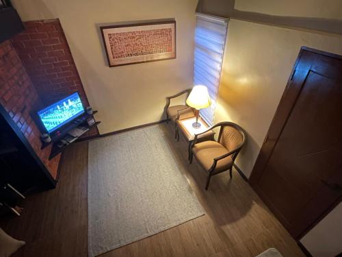 an overhead view of a living room with a table and a television at Grand Lodge Langkawi in Pantai Cenang
