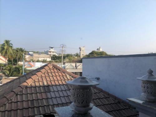 a balcony with two vases on a roof at Tulip Mui Ne in Phan Thiet