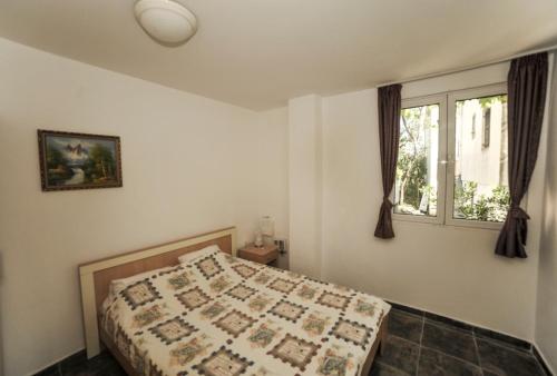 a bedroom with a bed and a window at Mijovic Apartments in Budva