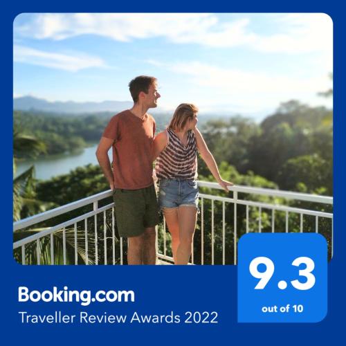 a man and a woman standing on a balcony at Mahaweli View Inn in Kandy