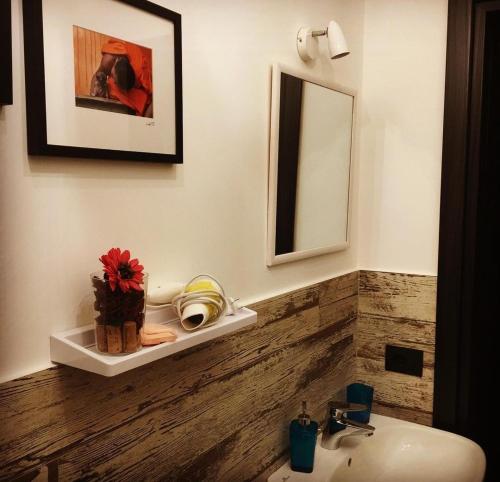 a bathroom with a sink and a mirror at CLARISSABEB in Fiumicino
