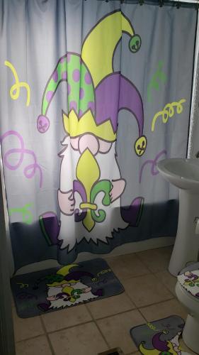 a shower curtain with a cartoon rabbit on it in a bathroom at The Lafayette House in Mobile