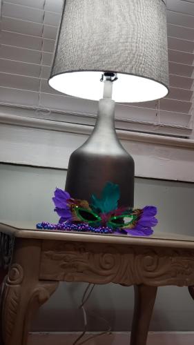 a lamp on a table with a flower on it at The Lafayette House in Mobile