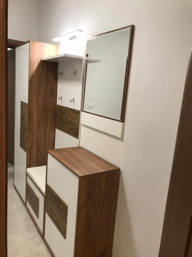 a bathroom with a mirror on a wall at Blue Sky in Skopje