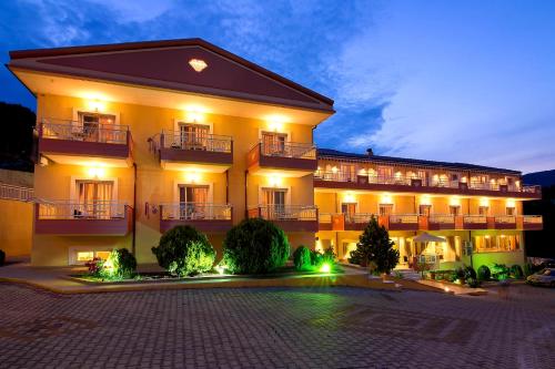 a large building with lights in front of it at Hotel Diamond in Limenaria