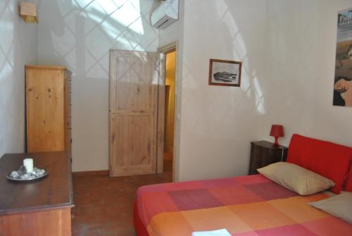a bedroom with a bed and a table and a window at SienaHomeAndSailing 2 in Siena