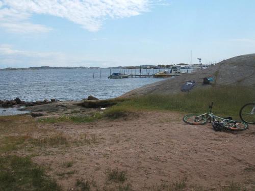 a bike parked on a beach next to a body of water at 3 person holiday home in TORSLANDA-By Traum in Hällsvik