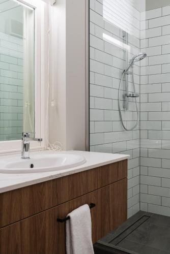 a bathroom with a sink and a shower at Premium Living on Stuart St in Dunedin