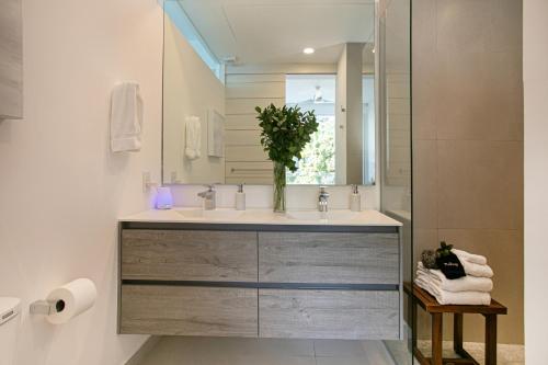 a bathroom with a sink and a mirror at Casa Elevar at Orchid in Puerto Vallarta