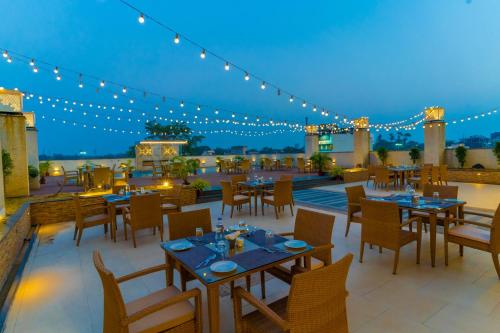 a restaurant with tables and chairs on a patio at Vivanta Jamshedpur, Golmuri in Jamshedpur