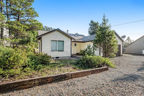 a house with a driveway in front of it at Three Capes Cottage in Pacific City
