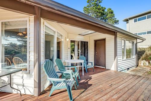 a patio with chairs and a table on a house at Three Capes Cottage in Pacific City