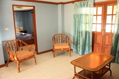 a living room with two chairs and a table at Lam Sai village hotel Koh Yao Noi in Ko Yao Noi