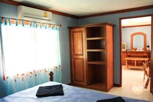 a bedroom with a bed and a book shelf at Lam Sai village hotel Koh Yao Noi in Ko Yao Noi