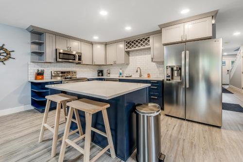 a kitchen with a large blue island and stools at SurfSide in Westport