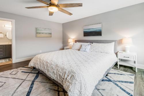 a bedroom with a bed and a ceiling fan at SurfSide in Westport