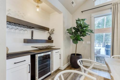 a kitchen with white cabinets and a table and a potted plant at Merganser Memories in Sunriver