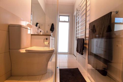 a bathroom with a toilet and a window in it at Coorong Island Retreat - Farm Stay at Pet Friendly Property in Meningie