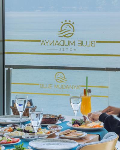 a table with food and wine glasses on it at BLUE MUDANYA HOTEL in Bursa