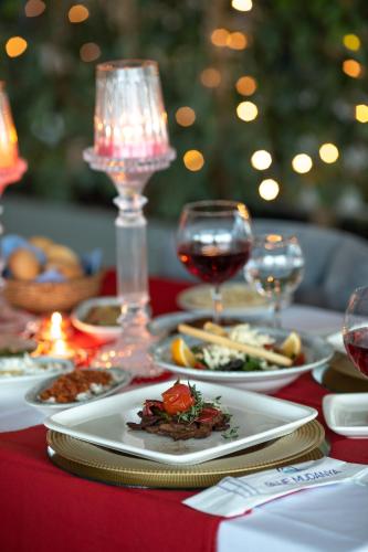 a table with plates of food and glasses of wine at BLUE MUDANYA HOTEL in Bursa