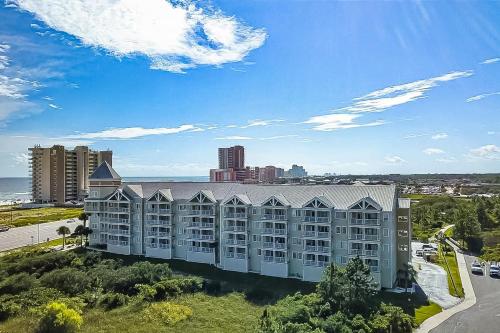 an aerial view of a large building with a city at Grand Caribbean #216 - Sandy Restoration in Orange Beach