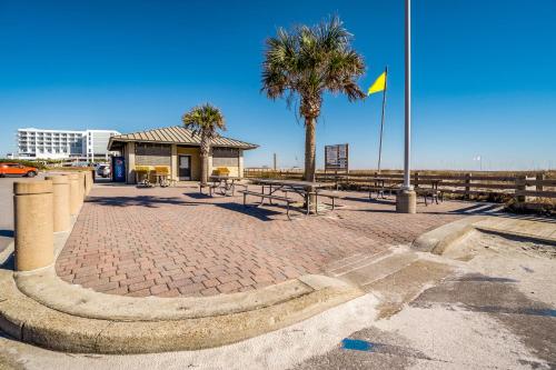 a flag on a pole on a brick sidewalk at Grand Caribbean #216 - Sandy Restoration in Orange Beach