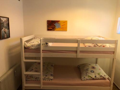 a bunk bed room with two bunk beds in it at TraunseeBlick in Altmünster