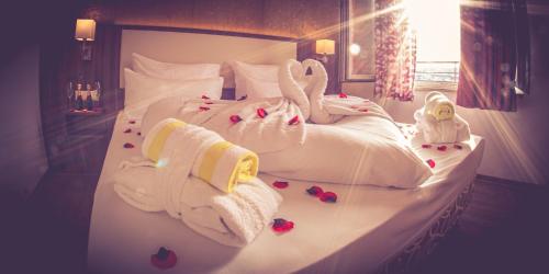 a hotel room with a bed with towels and flowers at DAS HÜRNER in Ansbach