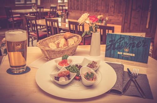a plate of food on a table with a glass of beer at DAS HÜRNER in Ansbach